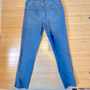 Light wash, raw hem above ankle skinny jeans.